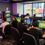 Dynamic online gaming experience at https://bomwin.jp.net/, with players engaged in high-tech games amidst neon lighting and vibrant city skyline.