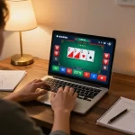 Engaging in a strategic sam86 poker game on laptop surrounded by betting notes.