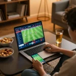 BONG88 user engaged in sports betting from home, showcasing live betting interface and cozy atmosphere